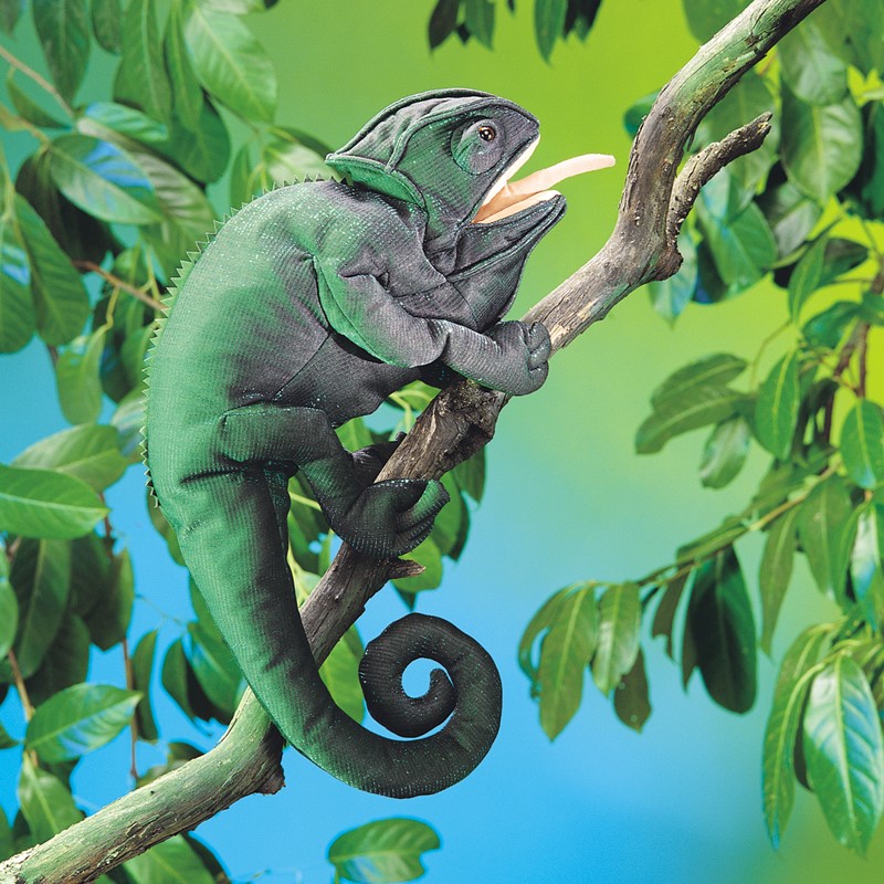 Folkmanis chameleon hand puppet in green and black with open mouth and curled tail, climbing on a branch