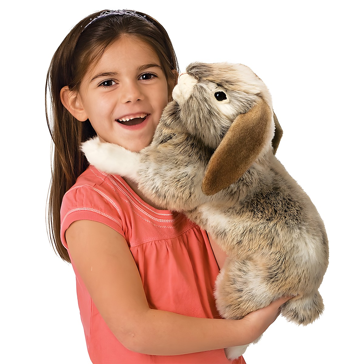 Mädchen hält die Folkmanis Handpuppe Widderkaninchen mit graubraun-meliertem Fell und herabhängenden Ohren in den Armen.