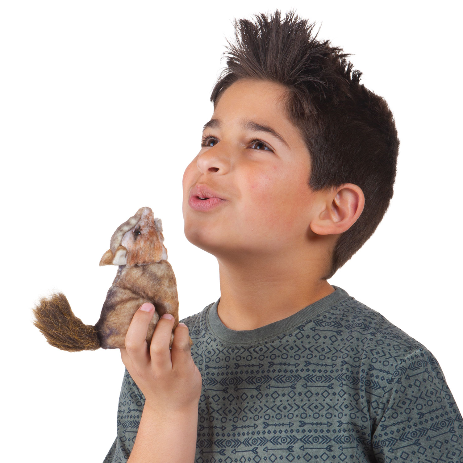 Boy holding a Folkmanis mini coyote finger puppet with brown fur and a bushy tail up in the air while looking upward