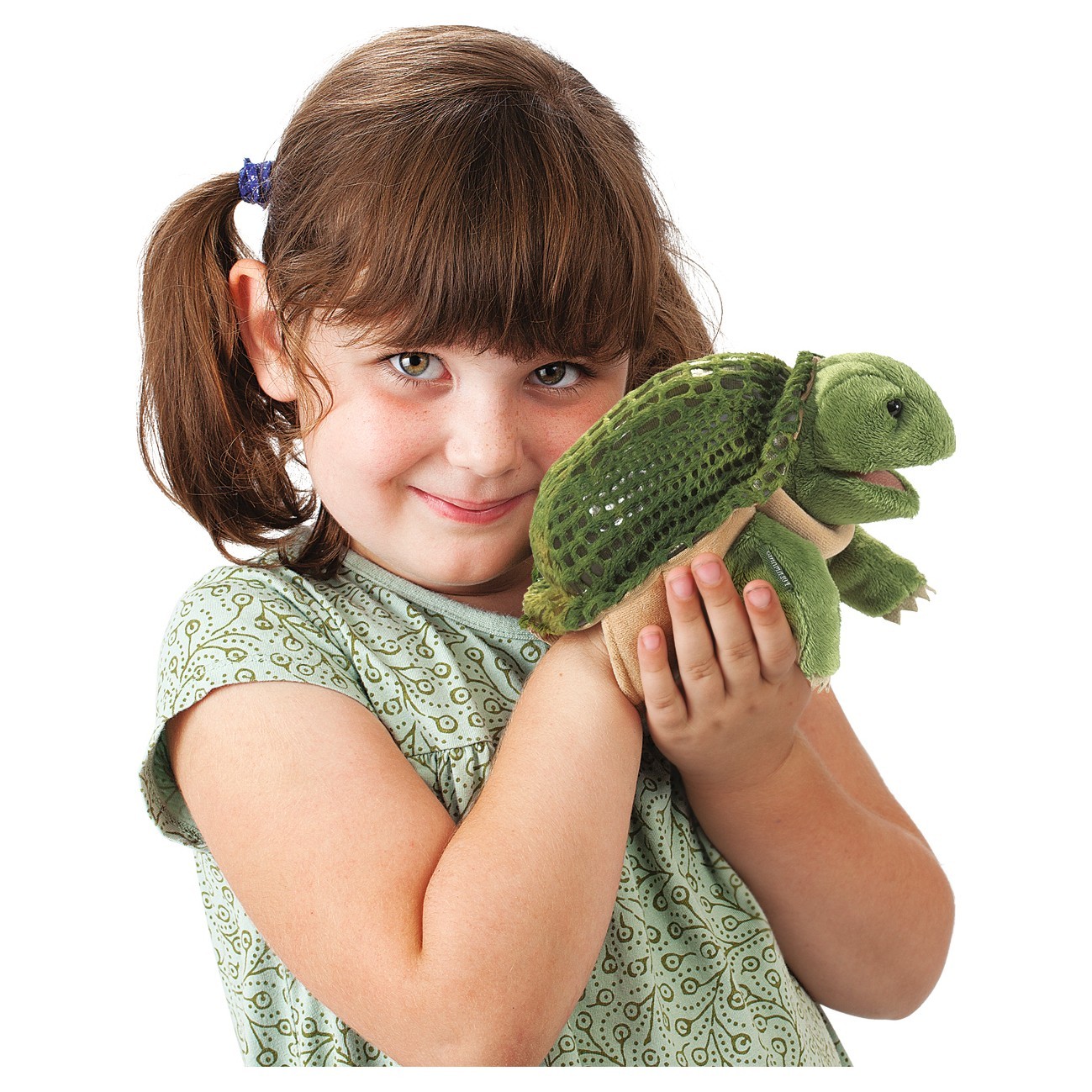 Girl holding the Folkmanis hand puppet little turtle with green shell and plush head in both hands