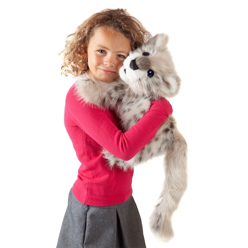 Girl holding the Folkmanis Baby Snow Leopard hand puppet with grey-white fur and dark spots in her arms