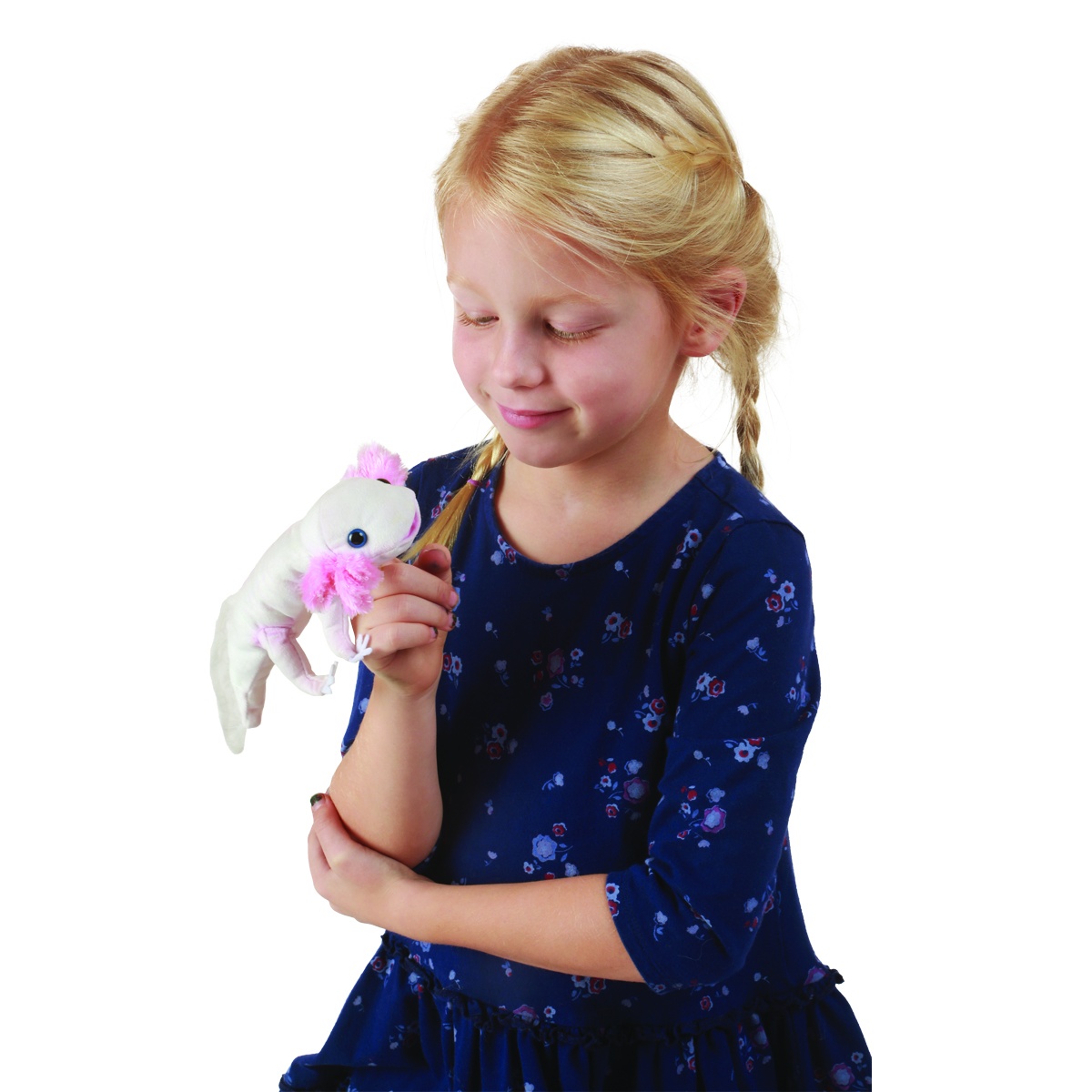 Girl holding a Folkmanis white axolotl finger puppet with pink gill tufts on her index finger and smiling at it