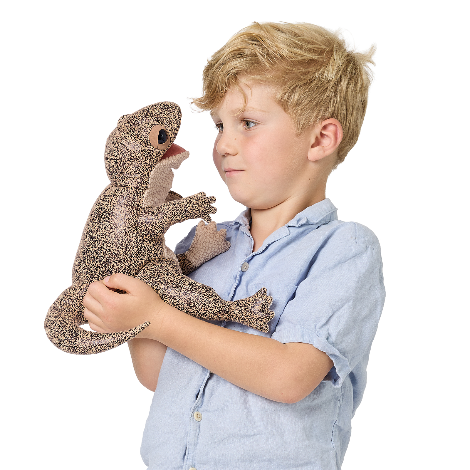 Boy holding a Folkmanis lizard hand puppet with brown-black patterned plush and movable mouth against a white background