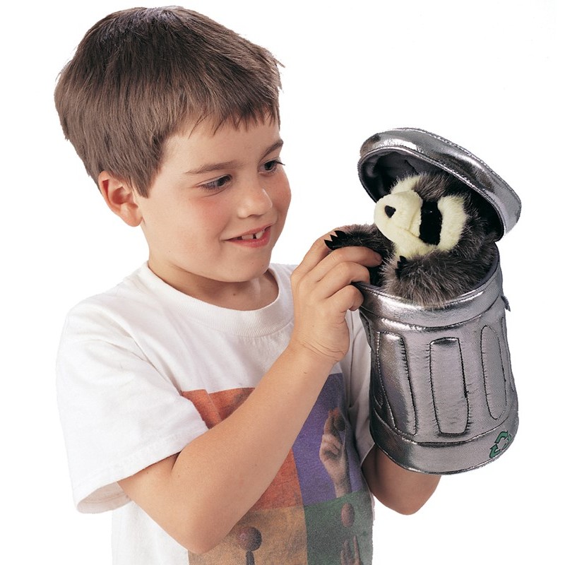 Boy holding the Folkmanis raccoon hand puppet inside a silver fabric garbage can with a flip-open lid