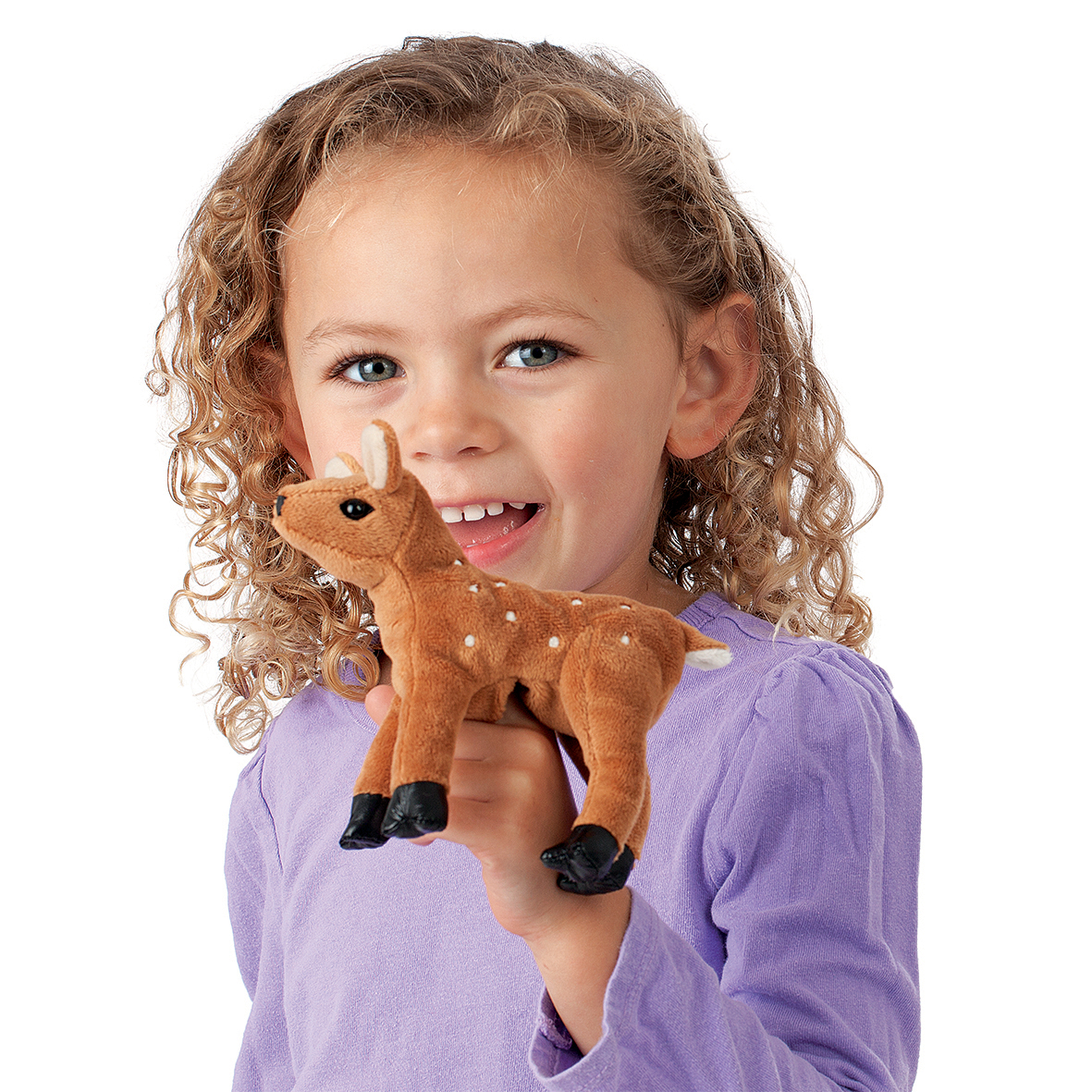 Smiling girl holding the Folkmanis mini fawn finger puppet with white spots and black hooves on her finger