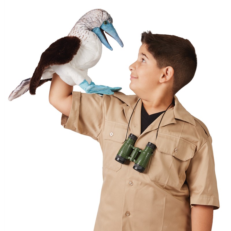 Boy with binoculars performing a Folkmanis blue-footed booby hand puppet with blue beak and feet on his raised hand