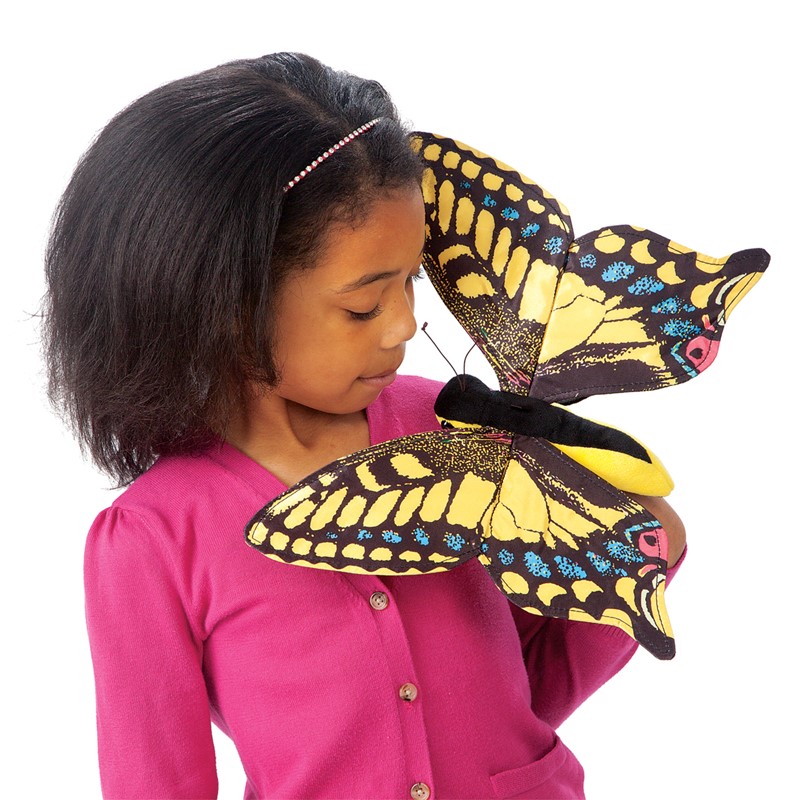 Folkmanis swallowtail butterfly hand puppet with yellow and black wings, held on a girl's hand