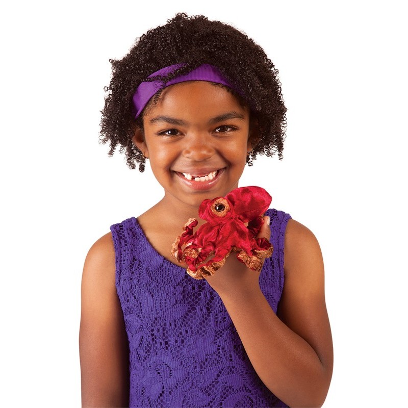 Girl holding a small red Folkmanis Mini Octopus finger puppet with brown tentacles on her hand
