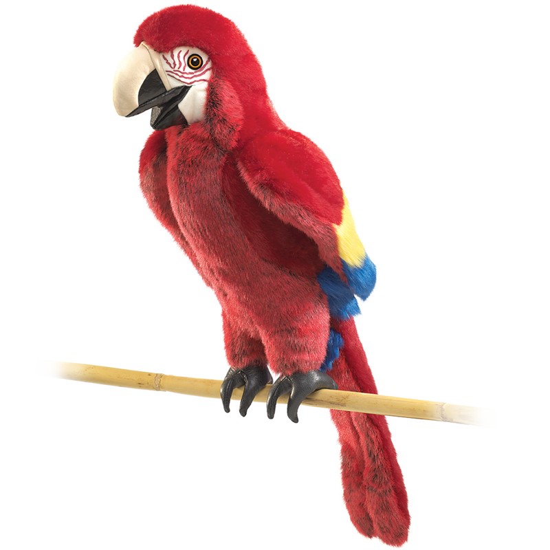 Folkmanis scarlet macaw hand puppet in vivid red with yellow-blue wing accents, perched on a bamboo stick, side view