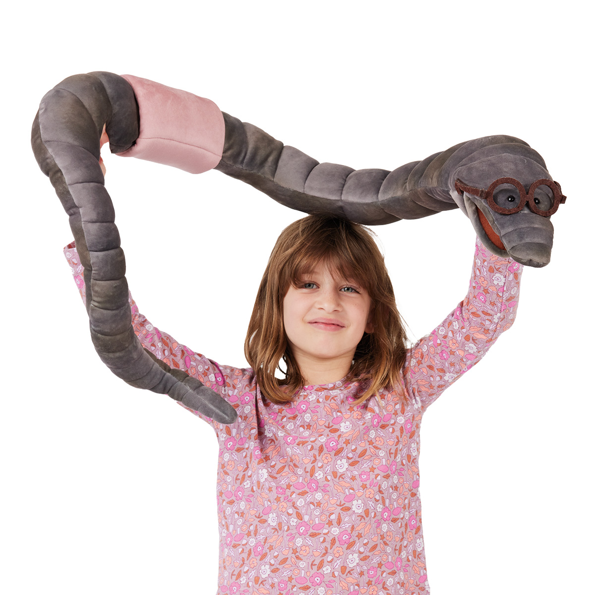 Girl holding the large Folkmanis bookworm hand puppet with a grey plush body and glasses above her head