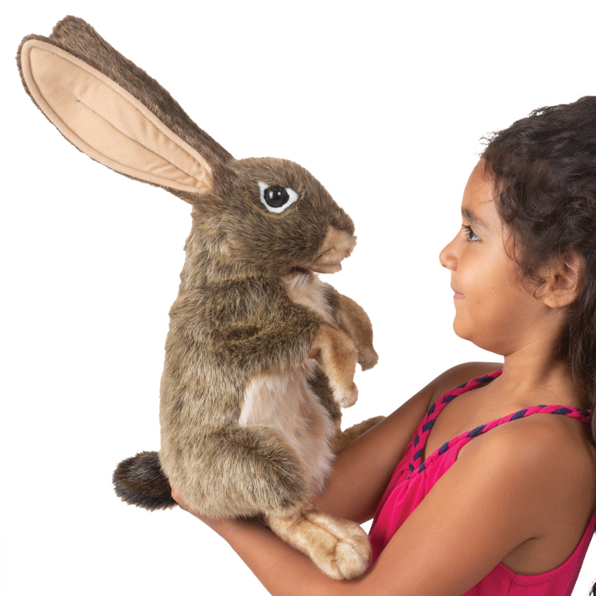 Girl holding the Folkmanis jack rabbit hand puppet with brown fur and upright ears on her hand