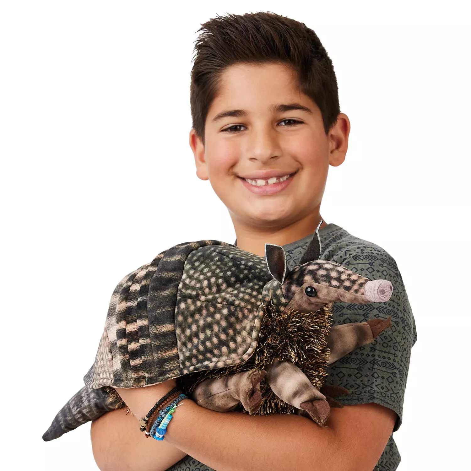 Boy holding a Folkmanis armadillo hand puppet with a detailed shell pattern and bristly belly in his arms