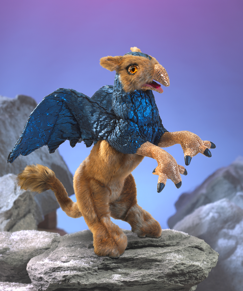Folkmanis griffin hand puppet with golden fur, metallic blue wings and bird talons, rearing up on a rock