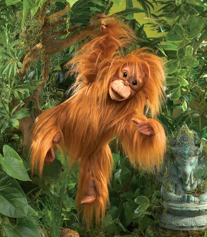 Folkmanis hand puppet baby orangutan with red shaggy fur, open mouth and outstretched arm against a green jungle background