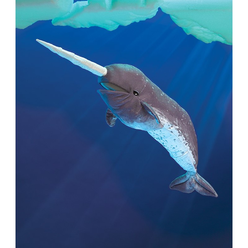 Folkmanis narwhal hand puppet in grey-blue with a long white horn, against a deep blue underwater background