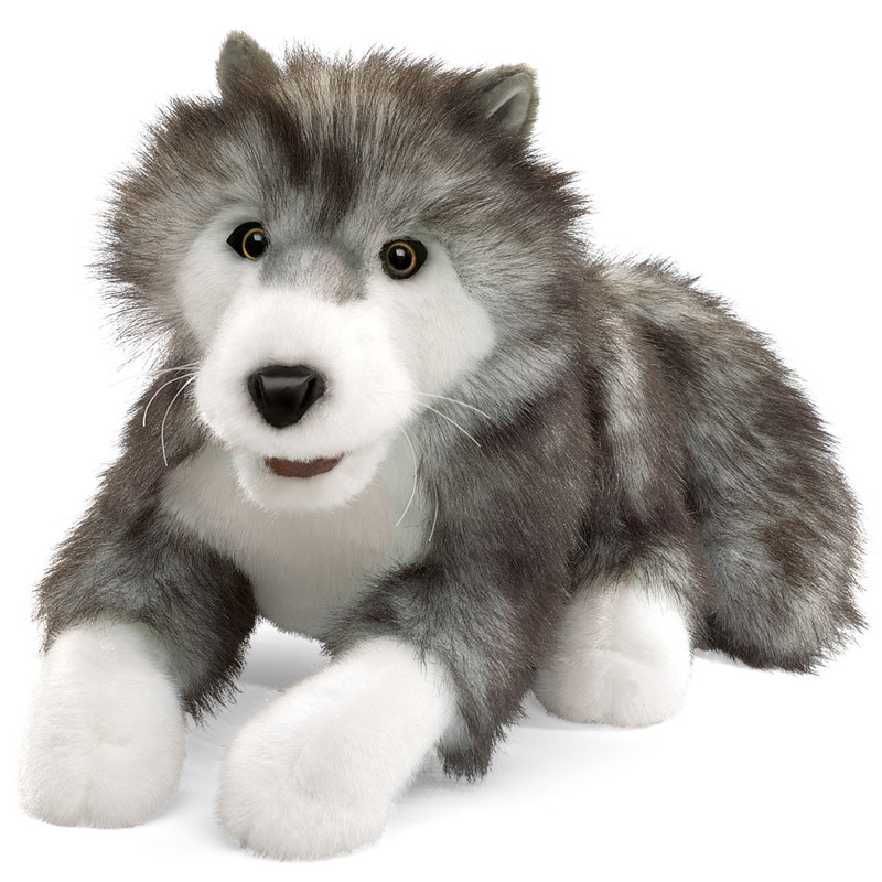 Folkmanis timber wolf hand puppet lying down, grey-white plush fur, amber eyes, slightly open mouth