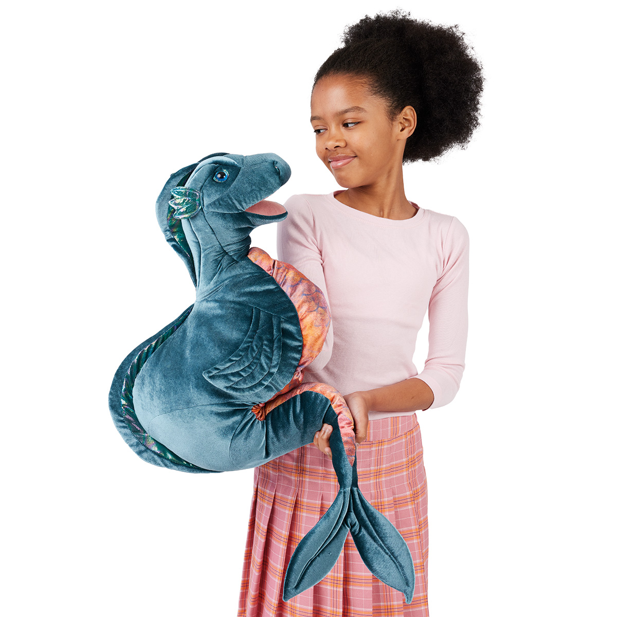 Girl holding the large Folkmanis Loch Ness Monster hand puppet made of blue velvet with orange fins in her arms