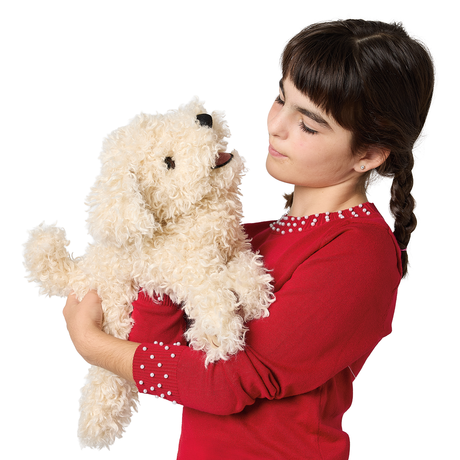 Girl in a red top holds the Folkmanis white poodle puppy hand puppet with curly cream fur at arm height, looking at it