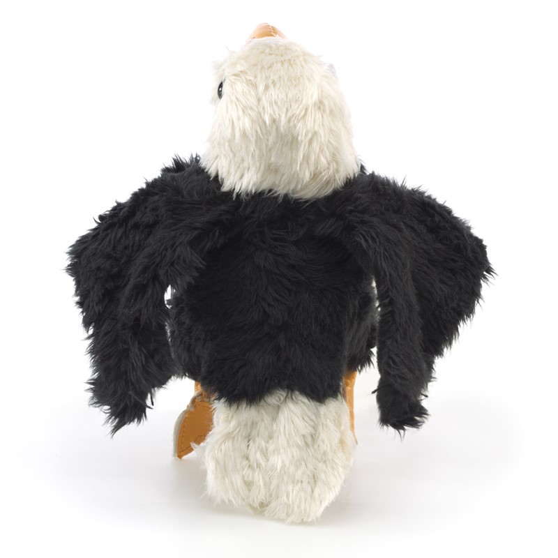 Folkmanis mini bald eagle finger puppet seen from behind, with black plumage, spread wings, and a white head