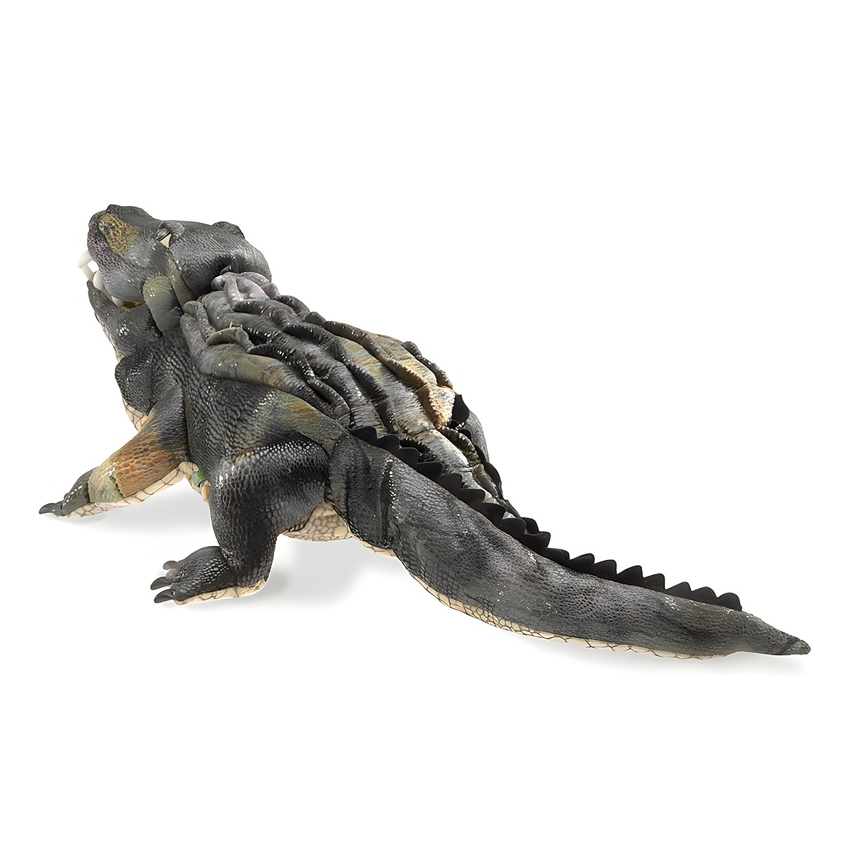 Folkmanis American Alligator hand puppet shown at an angle, with detailed textured scales in dark grey and olive brown, a jagged back ridge, and a long tail