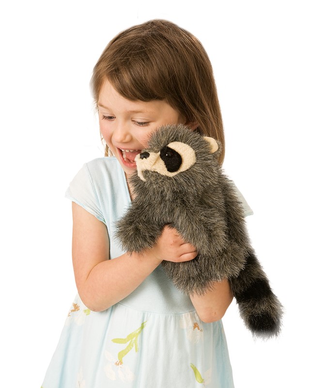 Laughing girl holding the Folkmanis baby raccoon hand puppet with grey fur and a ringed tail in both hands