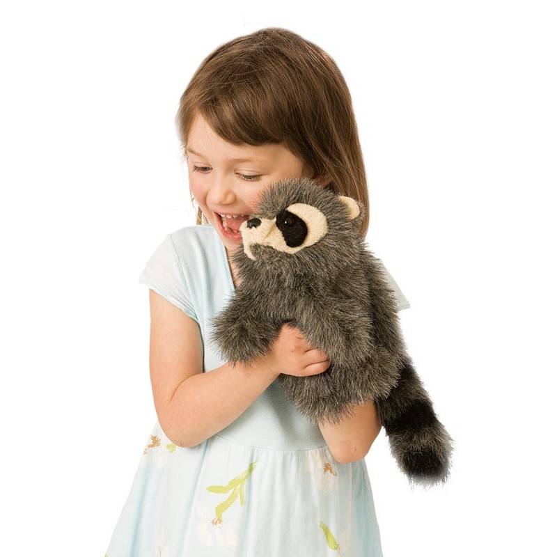 Laughing girl holding the Folkmanis baby raccoon hand puppet with grey fur and a ringed tail in both hands