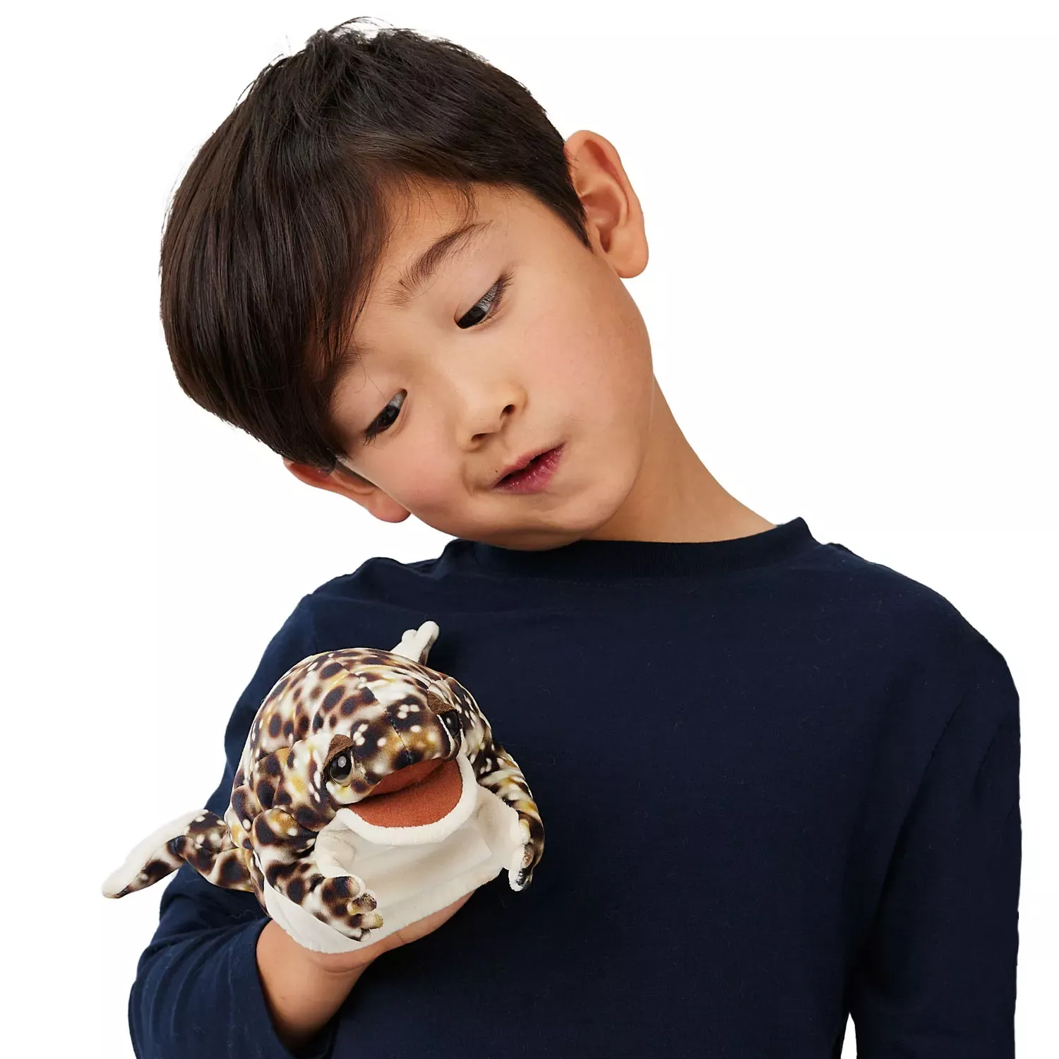 Boy holding a Folkmanis desert rain frog hand puppet with a brown-and-white spotted pattern and movable mouth