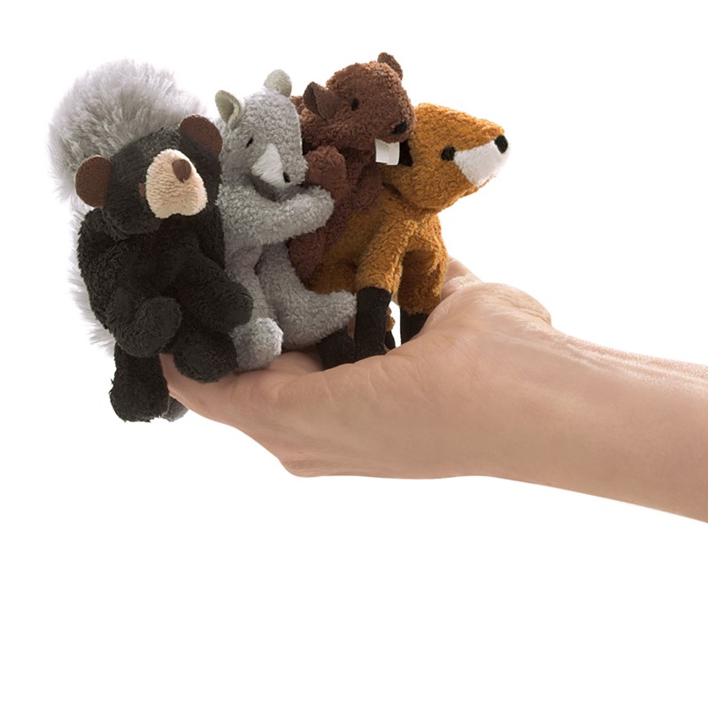 Four Folkmanis woodland animal finger puppets — skunk, squirrel, beaver and fox — held on one hand to show size comparison